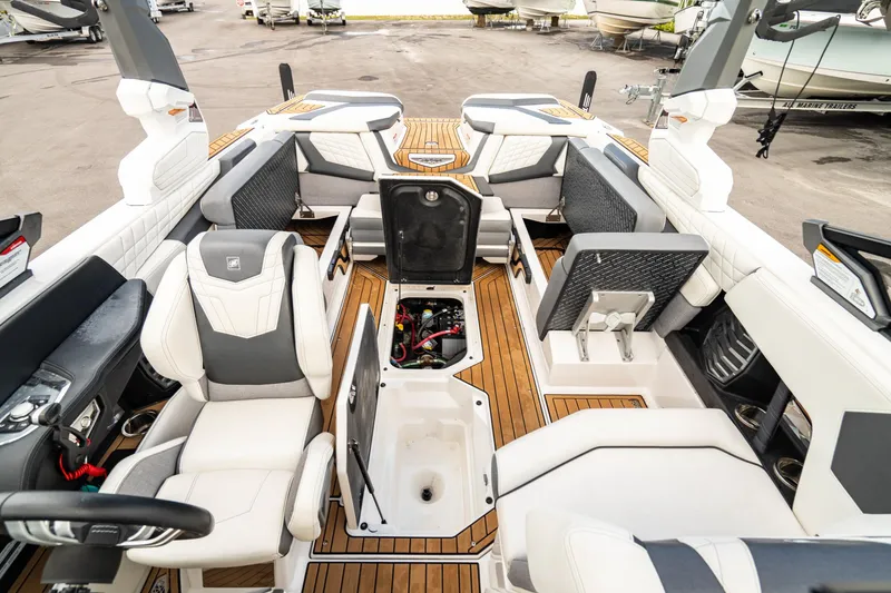 Slide: The Image of 2022 Nautique Super Air Nautique G23 interior with luxurious seating and storage compartments. - 26