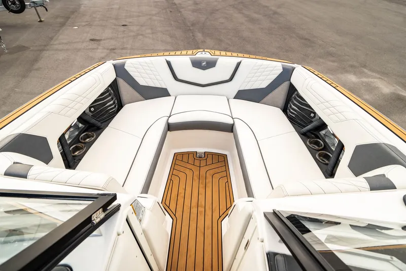 Slide: The Image of 2022 Nautique Super Air Nautique G23 boat interior with luxurious seating and teak flooring. - 3