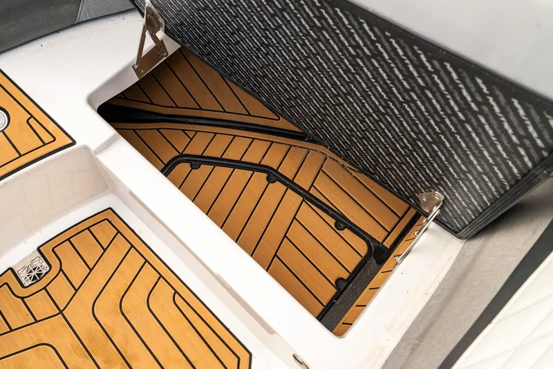 Slide: The Image of 2022 Nautique Super Air Nautique G23 storage compartment with stylish teak flooring. - 31
