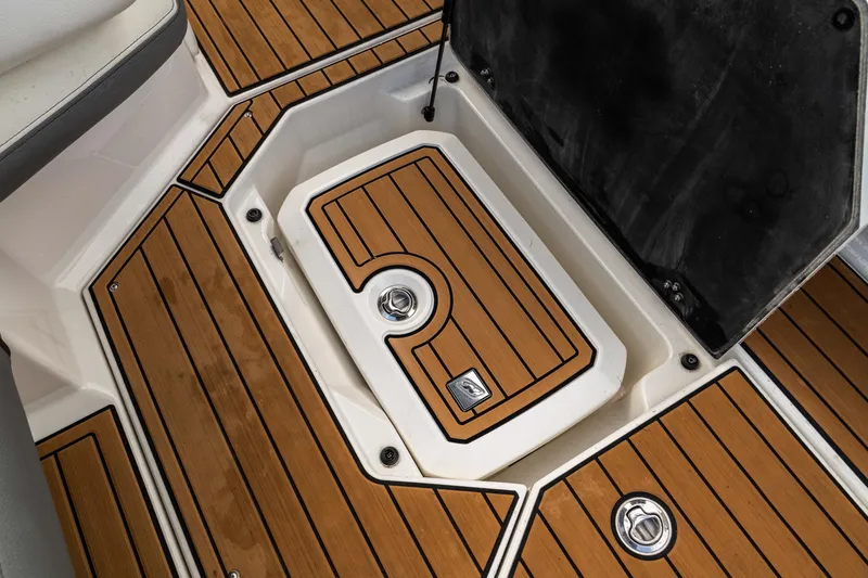 Slide: The Image of 2022 Nautique Super Air Nautique G23 boat deck with teak flooring and storage compartment. - 34