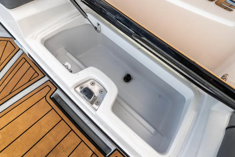 Slide: The Image of 2022 Nautique Super Air Nautique G23 storage compartment with teak flooring. - 39