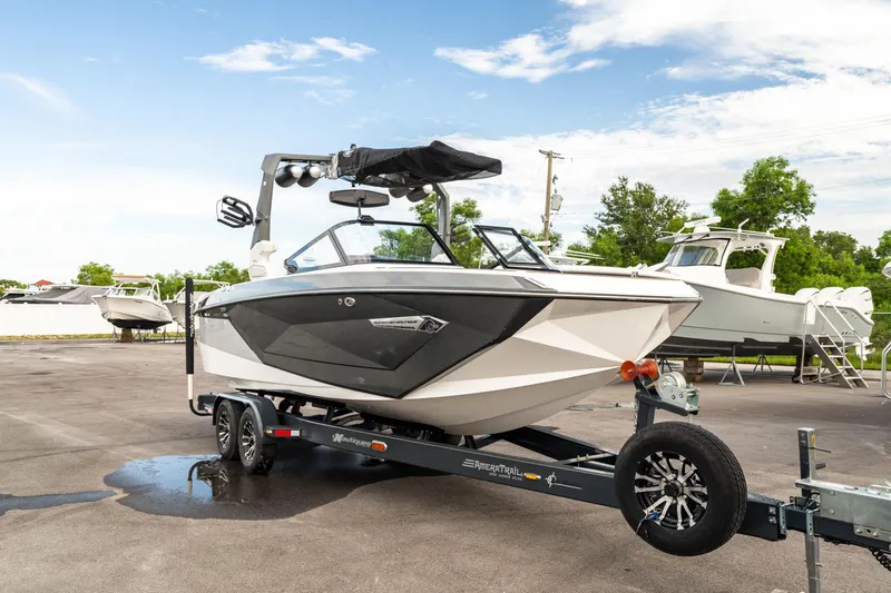 Slide: The Image of 2022 Nautique Super Air Nautique G23 boat on trailer, parked outdoors. - 40