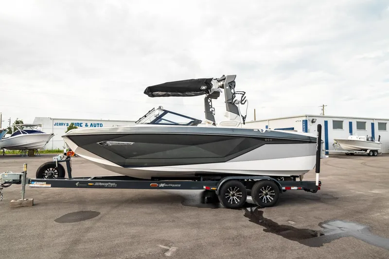 Slide: The Image of 2022 Nautique Super Air Nautique G23 boat on trailer, parked outdoors. - 44