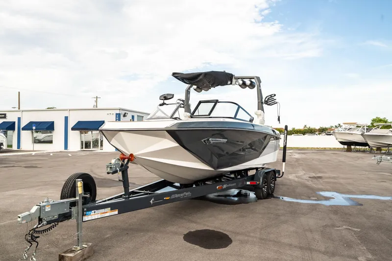 Slide: The Image of 2022 Nautique Super Air Nautique G23 boat on trailer in parking lot. - 45