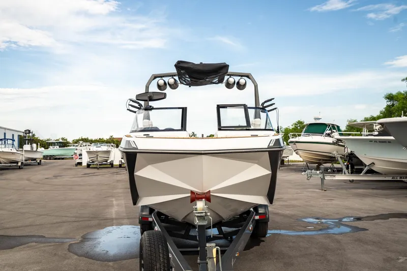 Slide: The Image of 2022 Nautique Super Air Nautique G23 boat on trailer, parked in marina. - 46