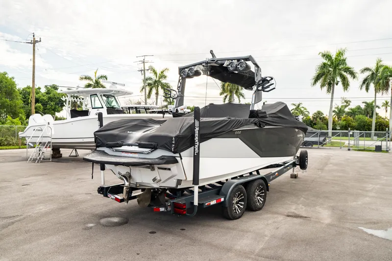 Slide: The Image of 2022 Nautique Super Air Nautique G23 boat on trailer, covered, parked outdoors. - 48