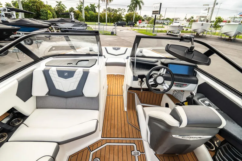 Slide: The Image of 2022 Nautique Super Air Nautique G23 boat interior with modern dashboard and seating. - 5