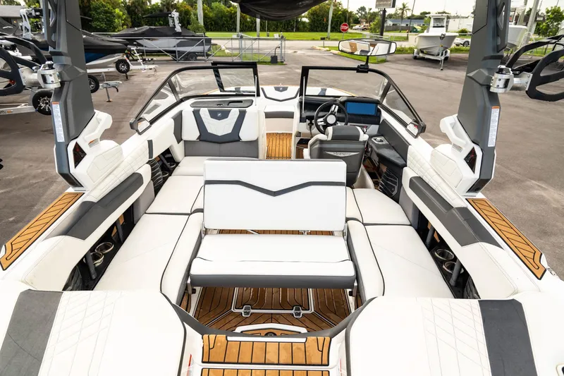 Slide: The Image of 2022 Nautique Super Air Nautique G23 interior with luxurious seating and modern dashboard. - 6