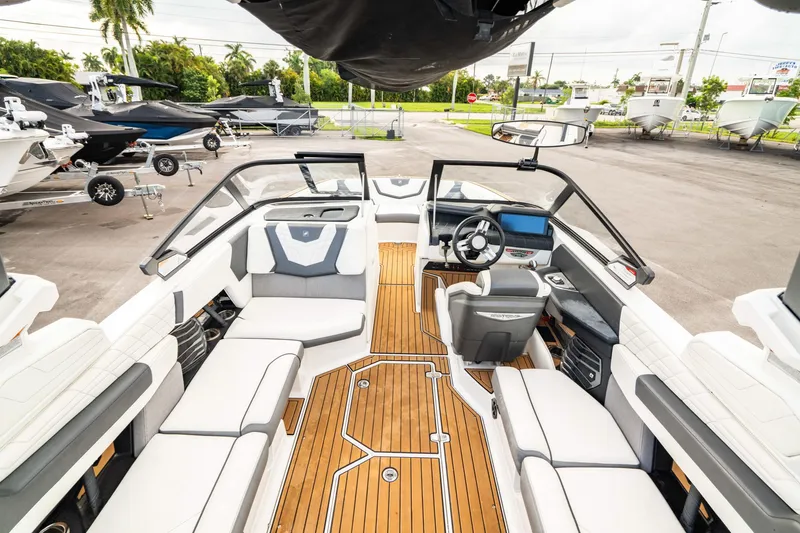 Slide: The Image of 2022 Nautique Super Air Nautique G23 boat interior with sleek seating and modern dashboard. - 9