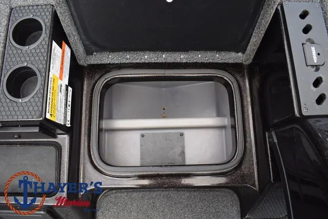 Slide: The Image of 2020 Triton 20 TRX Patriot boat storage compartment with cup holders and control panel. - 21