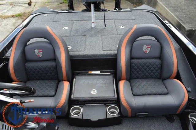 Slide: The Image of 2020 Triton 20 TRX Patriot boat interior with dual seats and storage compartments. - 27