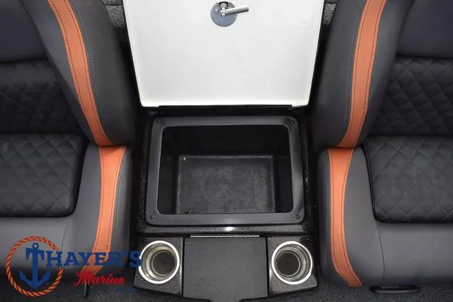 Slide: The Image of 2020 Triton 20 TRX Patriot boat interior with storage compartment and cup holders. - 28