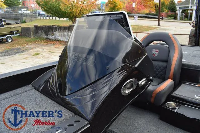 Slide: The Image of 2020 Triton 20 TRX Patriot boat interior with windshield and seating, Thayer's Marine logo visible. - 30