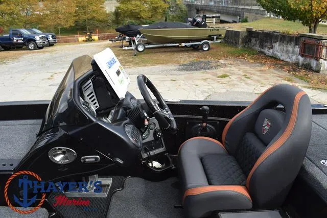 Slide: The Image of 2020 Triton 20 TRX Patriot boat interior with steering wheel and seating. - 31