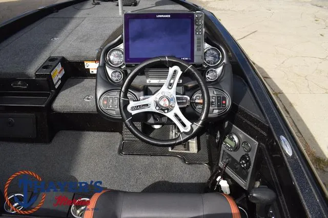Slide: The Image of 2020 Triton 20 TRX Patriot boat dashboard with steering wheel and navigation system. - 32
