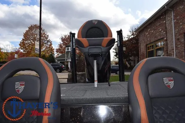 Slide: The Image of 2020 Triton 20 TRX Patriot boat seats with logo, outdoor setting, autumn trees. - 35