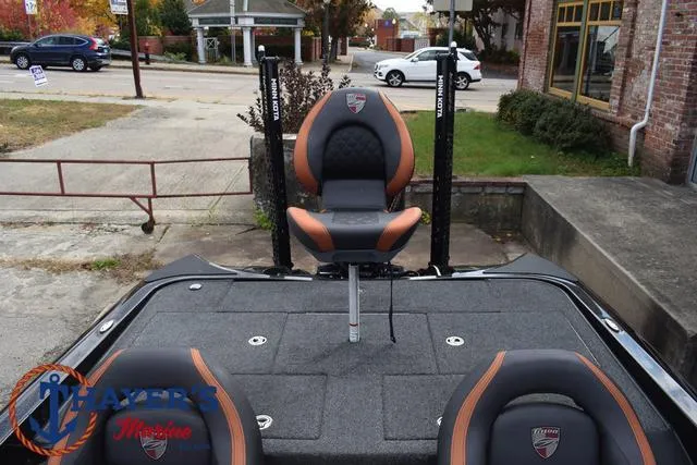 Slide: The Image of 2020 Triton 20 TRX Patriot boat with cushioned seats and fishing rod holders. - 36