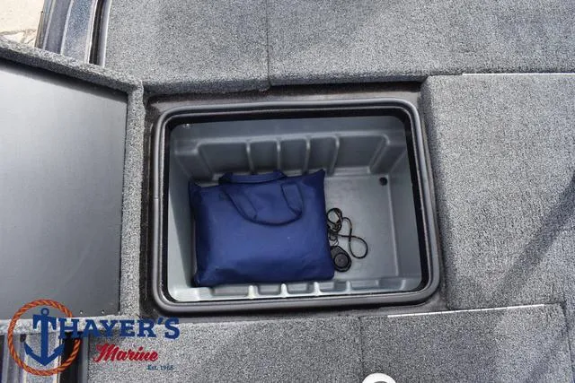 Slide: The Image of 2020 Triton 20 TRX Patriot storage compartment with blue bag and ropes. - 37