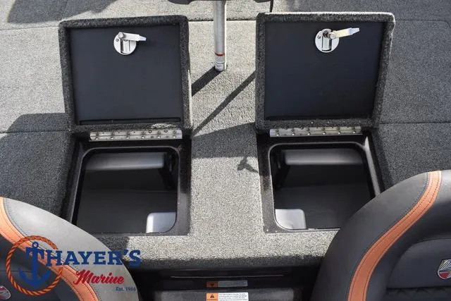 Slide: The Image of 2020 Triton 20 TRX Patriot boat storage compartments, open with visible interior. - 39