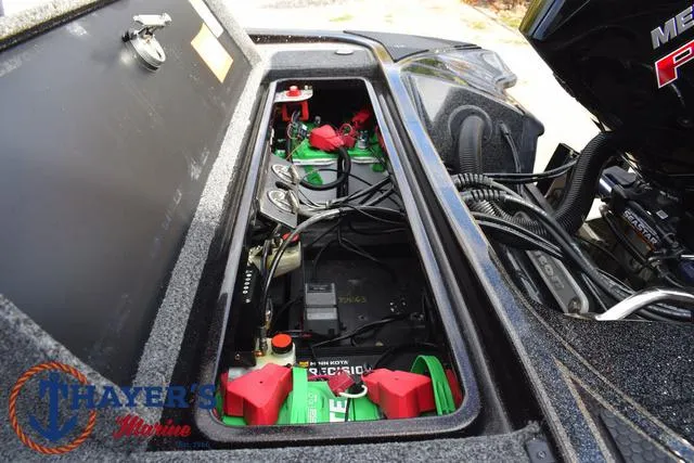 Slide: The Image of 2020 Triton 20 TRX Patriot boat battery compartment with wiring and components. - 40