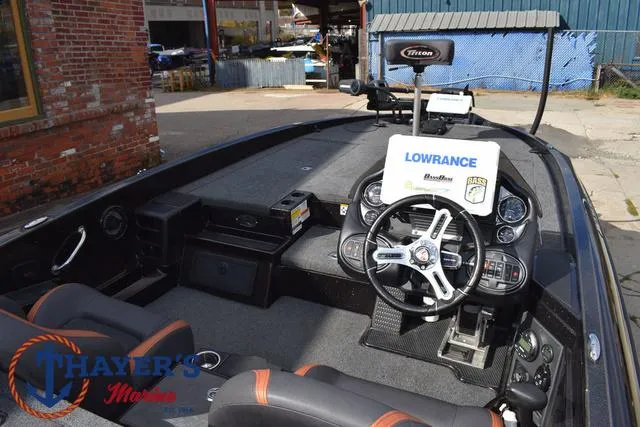 Slide: The Image of 2020 Triton 20 TRX Patriot boat interior with steering wheel and Lowrance electronics. - 44