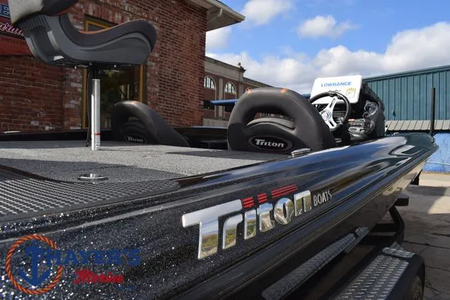 Slide: The Image of 2020 Triton 20 TRX Patriot boat, black exterior, parked outdoors. - 46