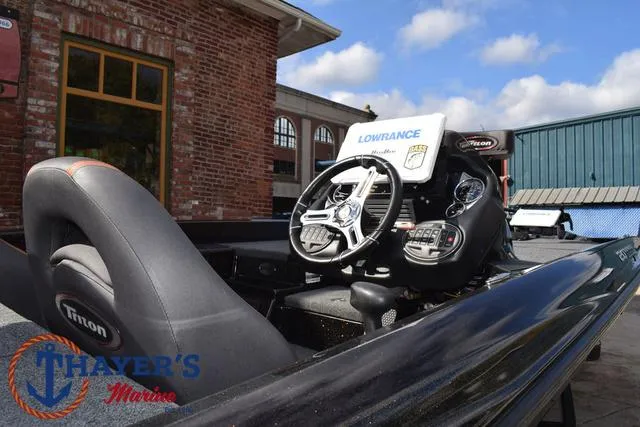 Slide: The Image of 2020 Triton 20 TRX Patriot boat interior with steering wheel and Lowrance electronics. - 47