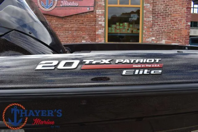 Slide: The Image of 2020 Triton 20 TRX Patriot Elite boat, Thayer's Marine logo, brick wall background. - 6