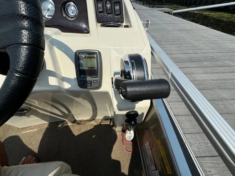 Slide: The Image of Control panel of a 2014 Bennington 24 SLX3 boat with steering wheel and throttle. - 16
