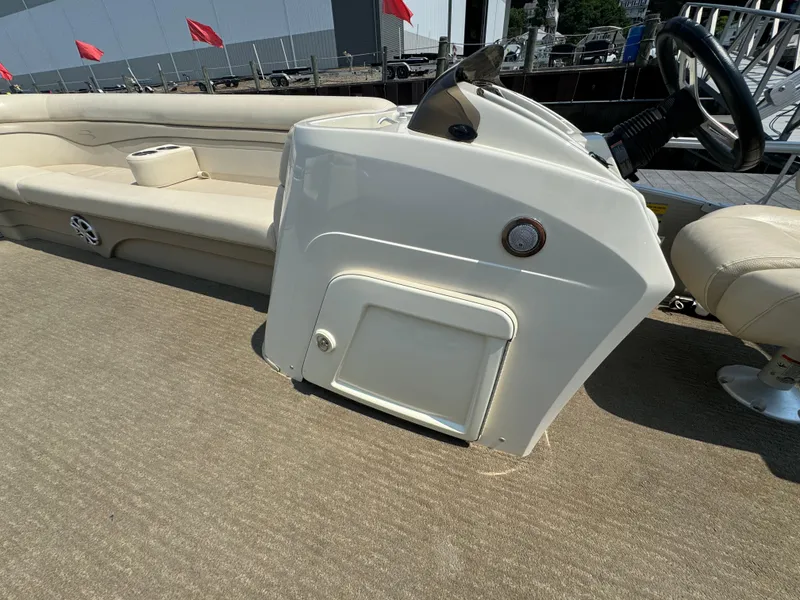 Slide: The Image of 2014 Bennington 24 SLX3 boat interior with beige seating and control console. - 18