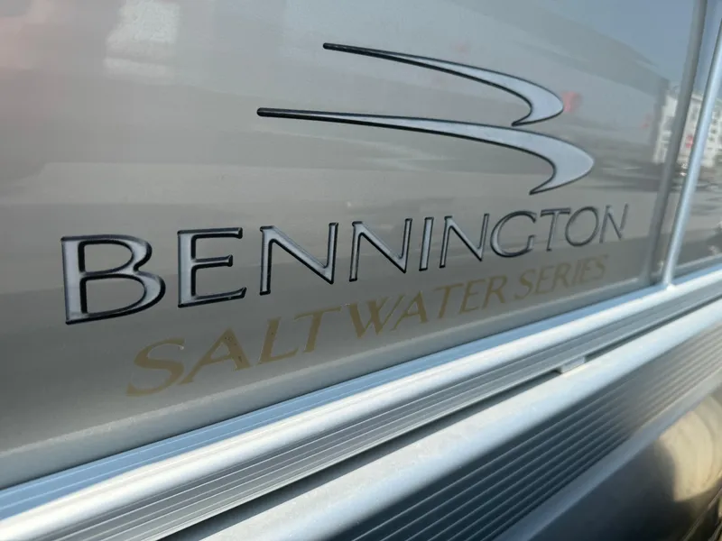 Slide: The Image of Close-up of 2014 Bennington 24 SLX3 Saltwater Series logo on boat exterior. - 2