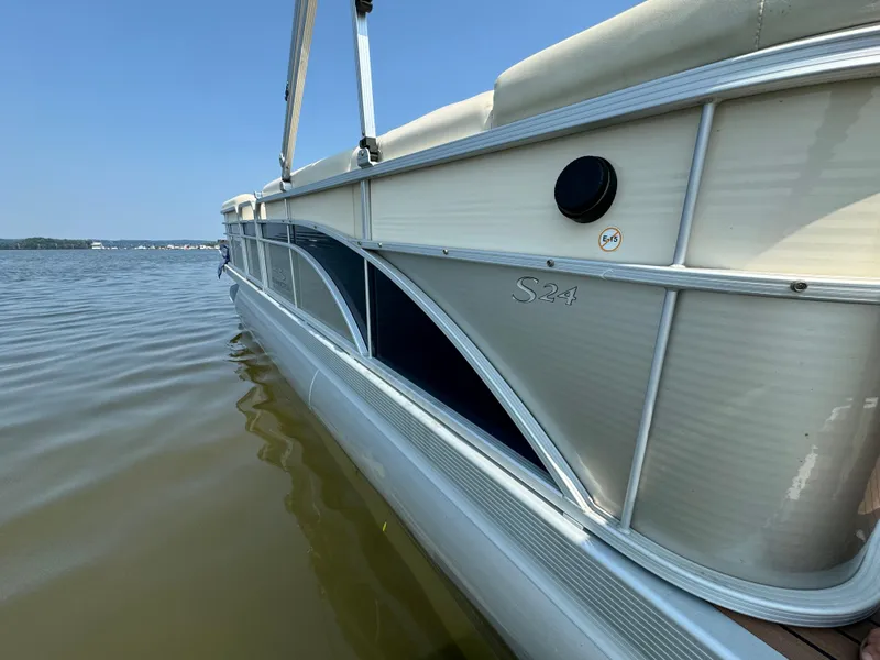 Slide: The Image of 2014 Bennington 24 SLX3 pontoon boat on calm water, side view. - 3