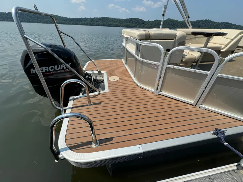 Slide: The Image of 2014 Bennington 24 SLX3 pontoon boat with Mercury engine on a calm lake. - 5