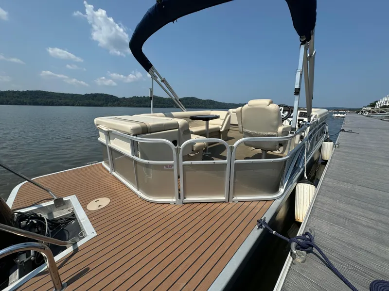 Slide: The Image of 2014 Bennington 24 SLX3 pontoon boat docked on a sunny day. - 7