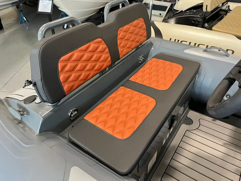Slide: The Image of 2024 Highfield Sport 360 boat with orange quilted seats and sleek interior design. - 3