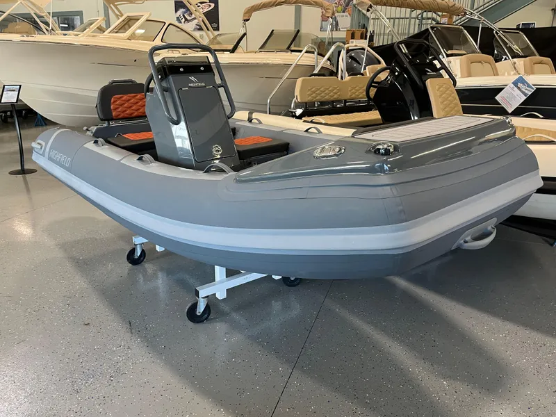 Slide: The Image of 2024 Highfield Sport 360 inflatable boat in showroom, featuring sleek gray design. - 6