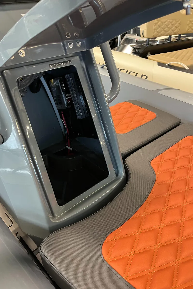 Slide: The Image of 2024 Highfield Sport 360 boat interior with orange quilted seats and storage compartment. - 8