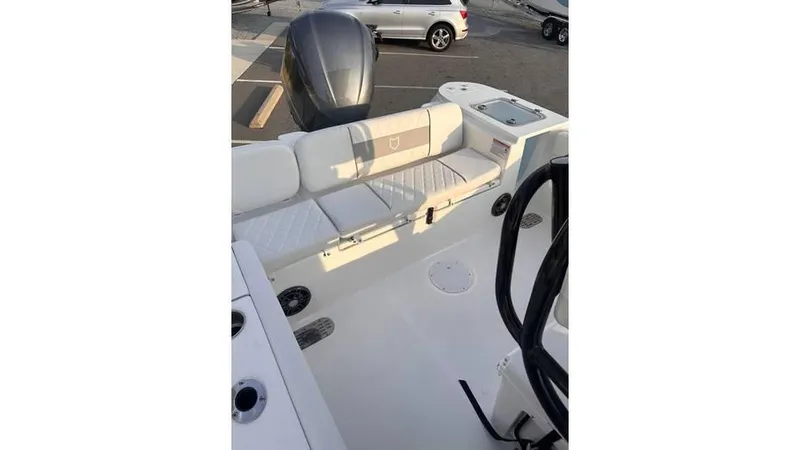 Slide: The Image of 2025 Sea Fox 248 Commander boat interior with seating and motor, docked outdoors. - 12