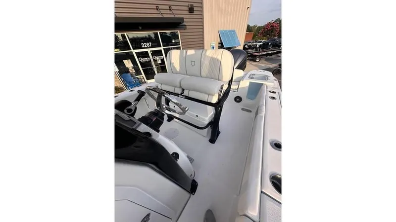 Slide: The Image of 2025 Sea Fox 248 Commander boat interior with seating and console, displayed outdoors. - 14