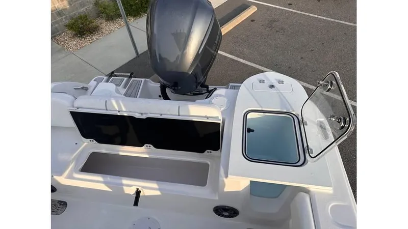 Slide: The Image of 2025 Sea Fox 248 Commander boat interior with open storage and engine view. - 15