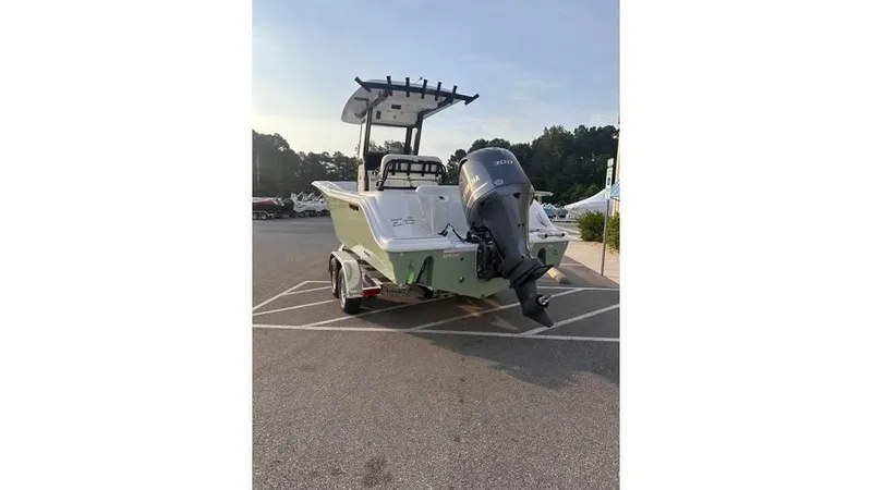 Slide: The Image of 2025 Sea Fox 248 Commander boat with outboard motor in a parking lot. - 16