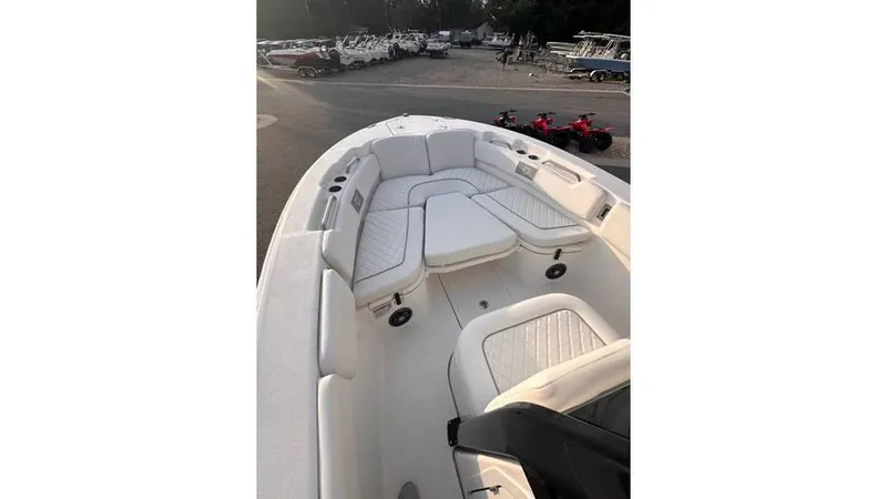 Slide: The Image of 2025 Sea Fox 248 Commander boat interior with white seating, parked outdoors. - 9
