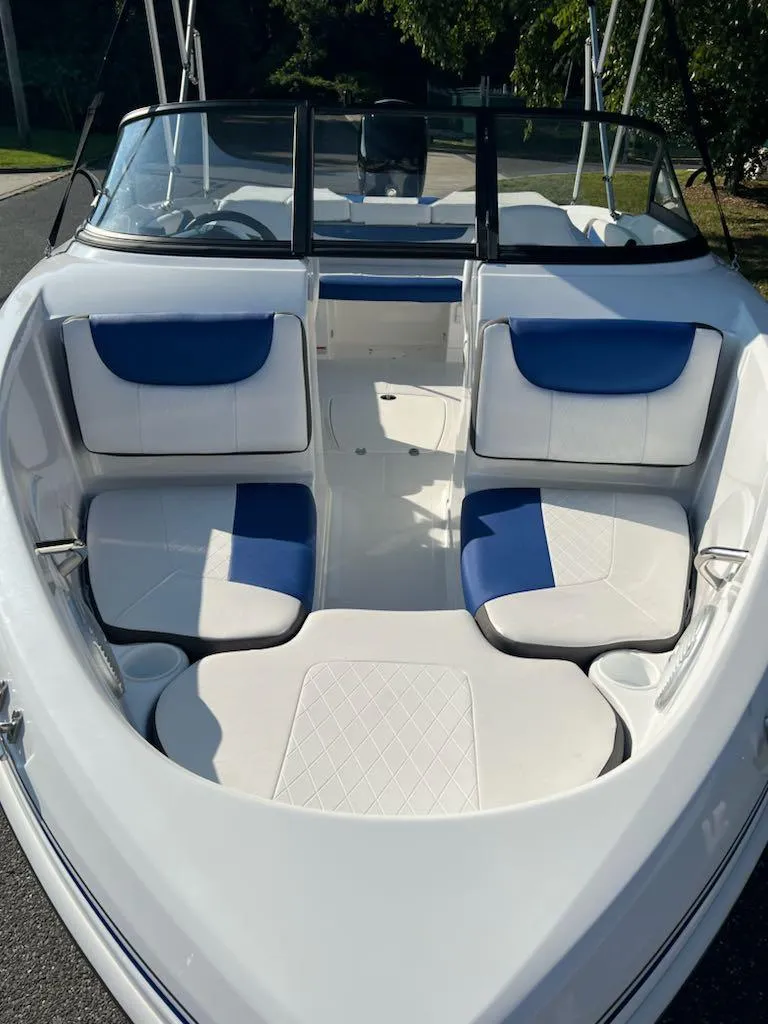 Slide: The Image of 2024 Tahoe 200 S boat interior with white and blue seating. - 11