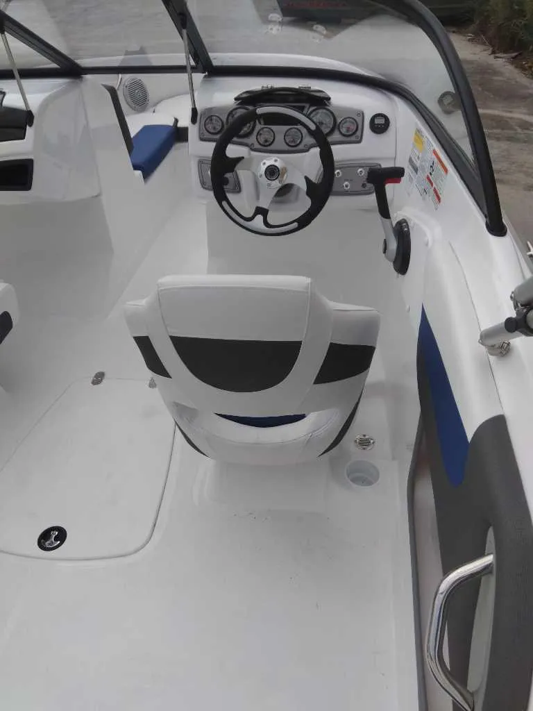 Slide: The Image of 2024 Tahoe 200 S boat interior with steering wheel and seating. - 3