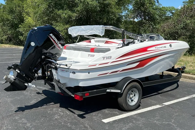 Slide: The Image of 2024 Tahoe T18 boat with trailer, parked outdoors, featuring red and white design. - 3