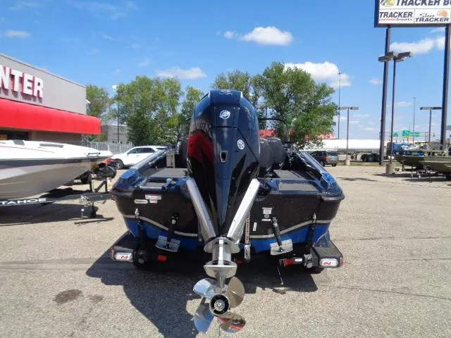 Slide: The Image of 2024 Nitro ZV20 Pro boat with powerful outboard motor in a dealership lot. - 2