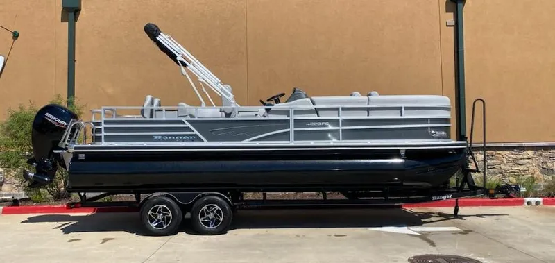Slide: The Image of 2024 Ranger Reata 220FC pontoon boat on trailer, side view. - 2