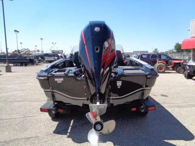 Slide: The Image of 2024 Nitro ZV20 boat with powerful outboard motor, parked in a lot under clear blue sky. - 3