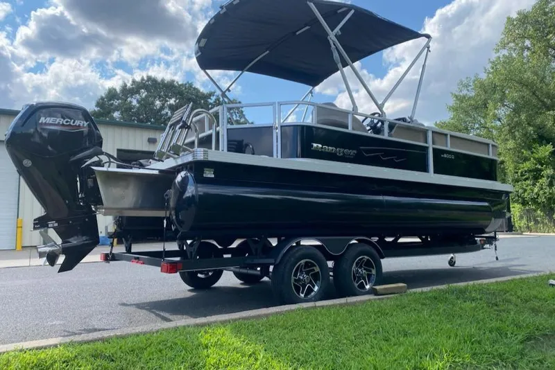 Slide: The Image of 2024 Ranger Reata 200C pontoon boat with Mercury engine on trailer. - 10