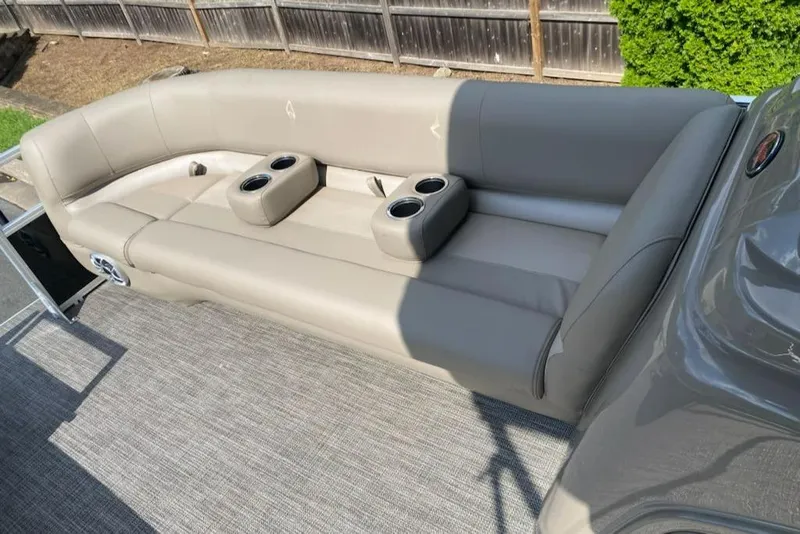 Slide: The Image of 2024 Ranger Reata 200C boat interior with gray seating and cup holders. - 3
